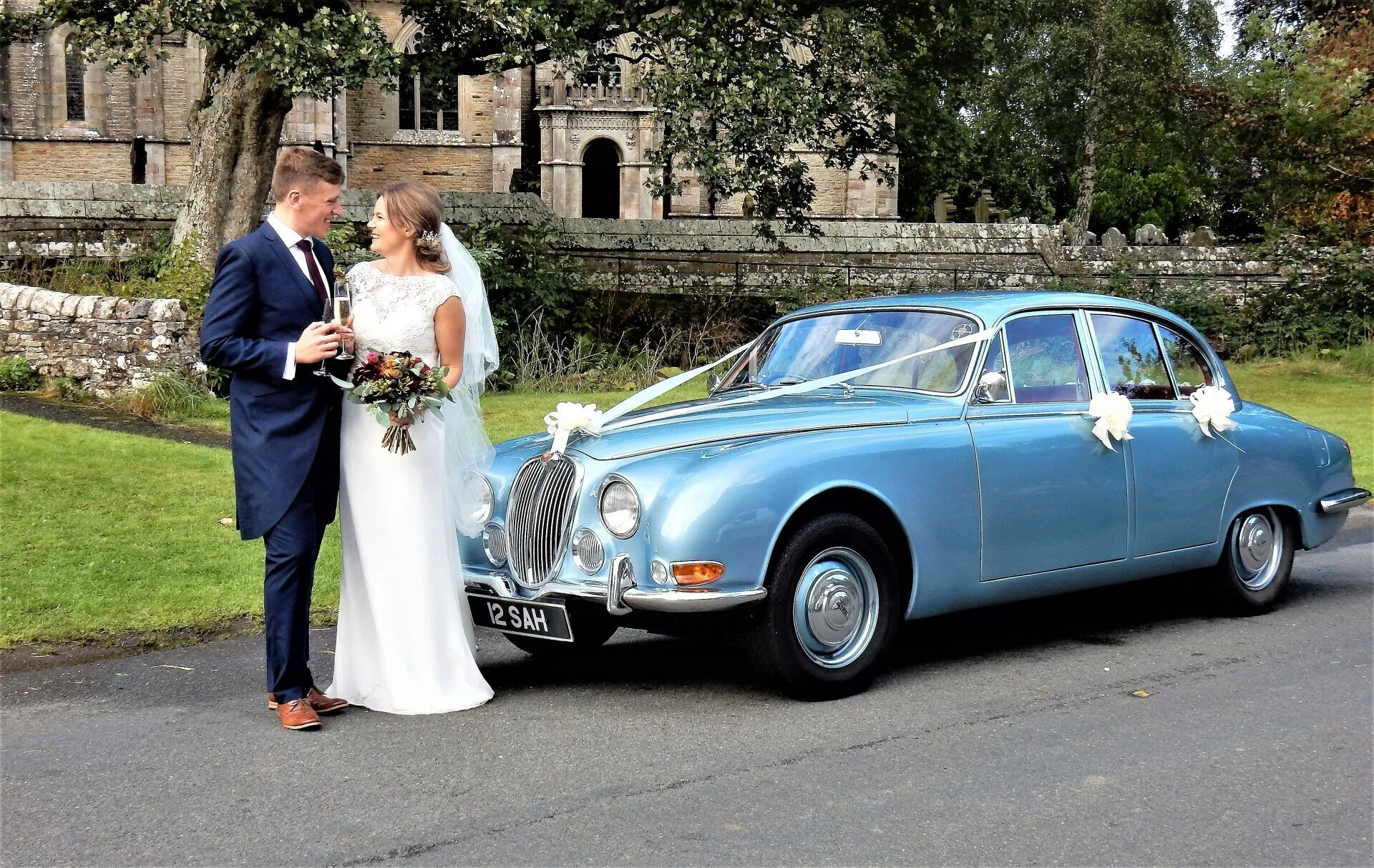 Classic wedding car outside a Lake District chapel